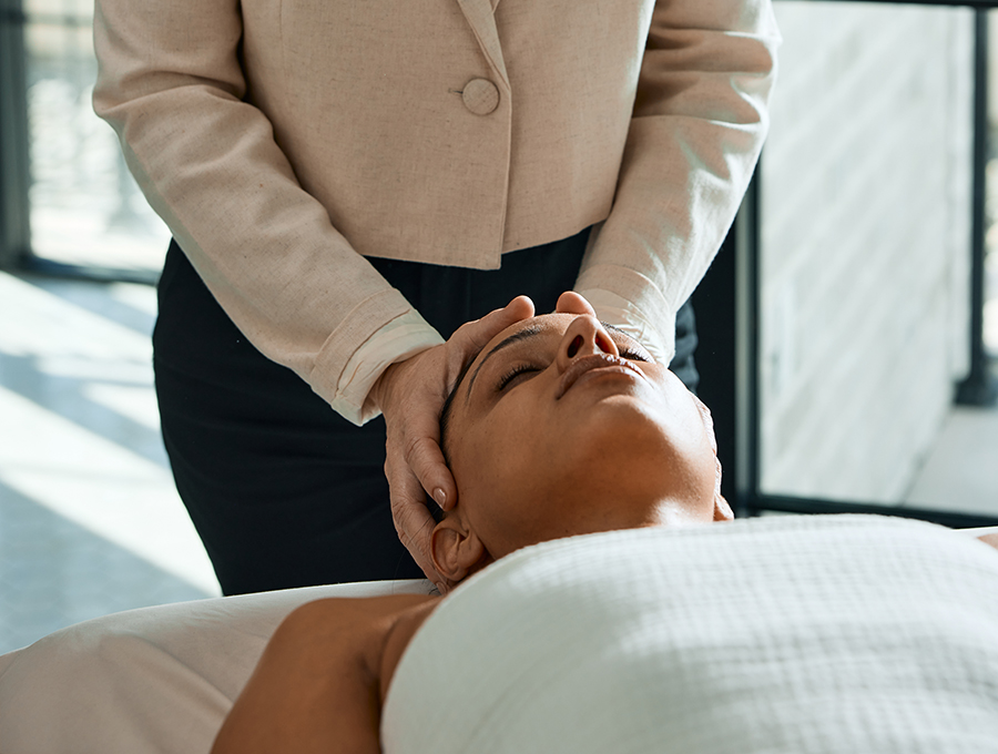A woman getting her face massaged in a spa